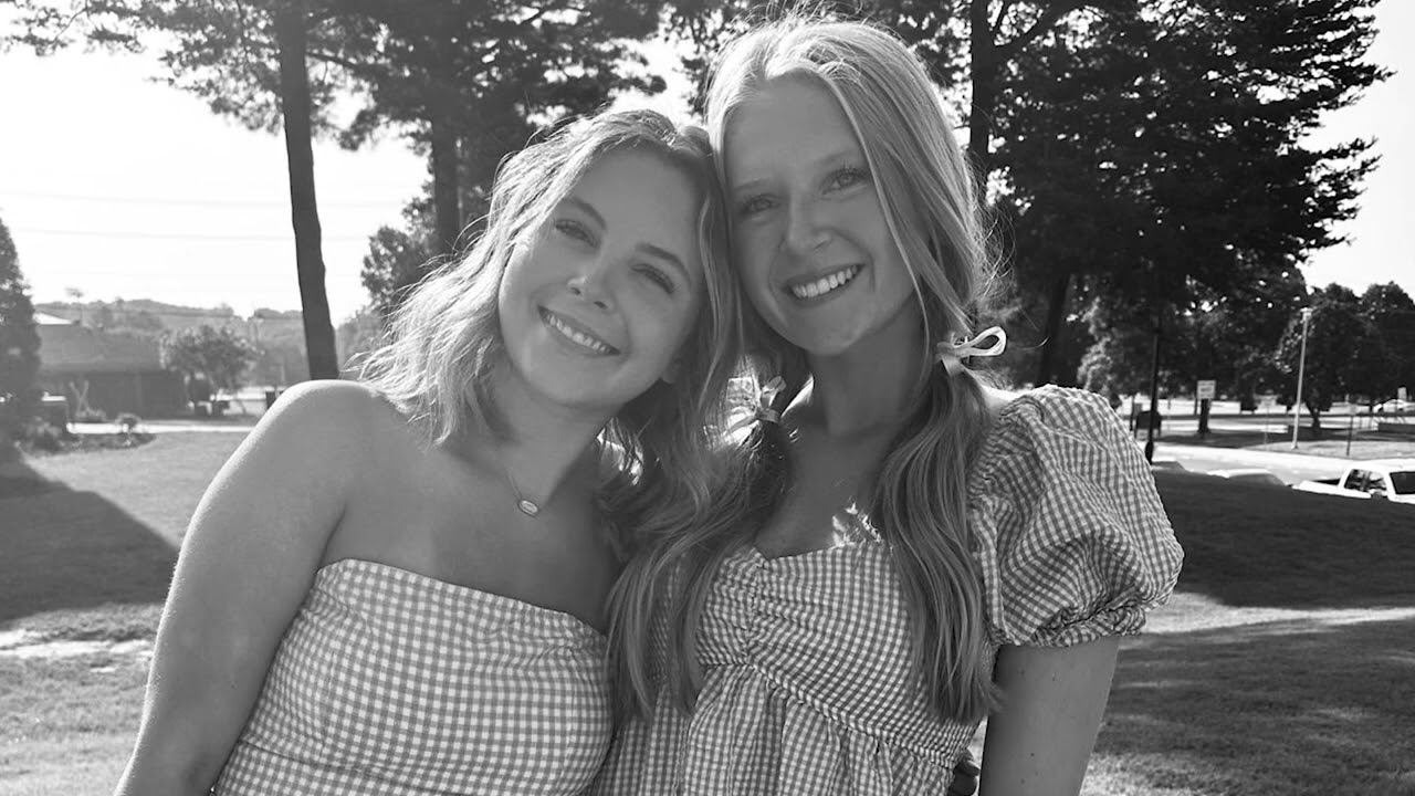 Two members in a black-and-white portrait