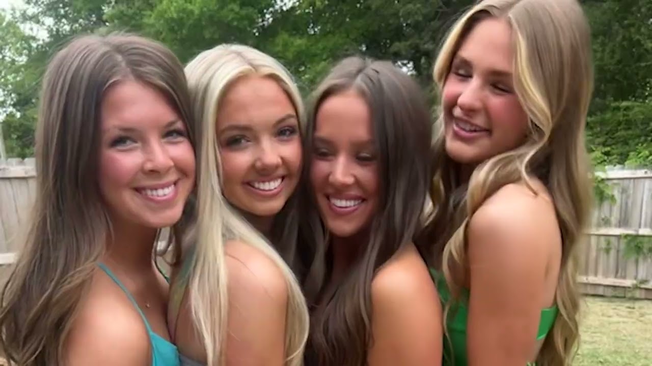 Four members smiling outdoors